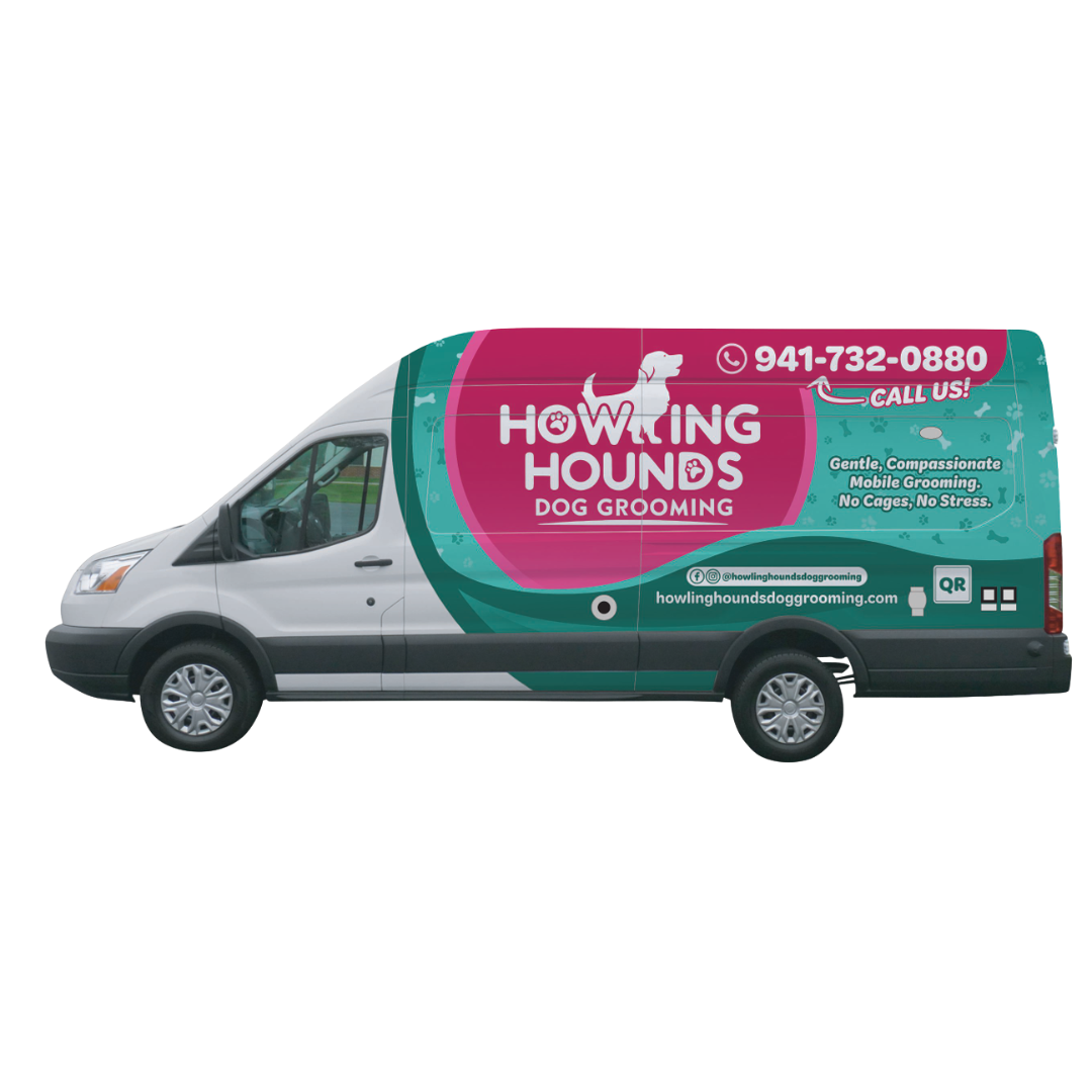 A white van with a pink and green advertisement for howling hounds dog grooming.