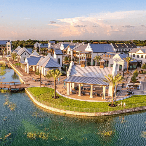 An aerial view of a small town next to a body of water.