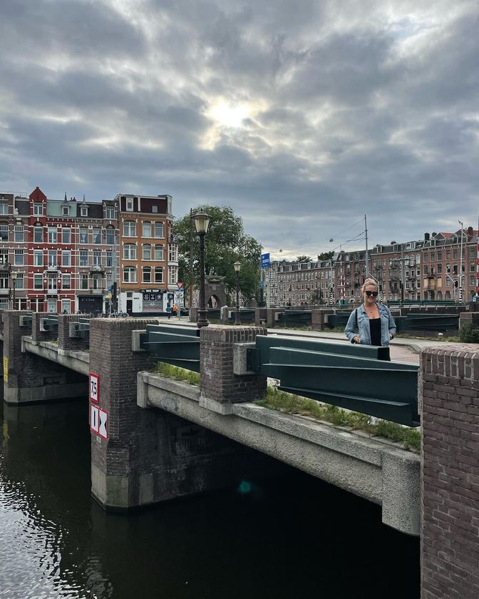 Whitney Lawson stands along a canal in Amsterdam | SWELL Strategy