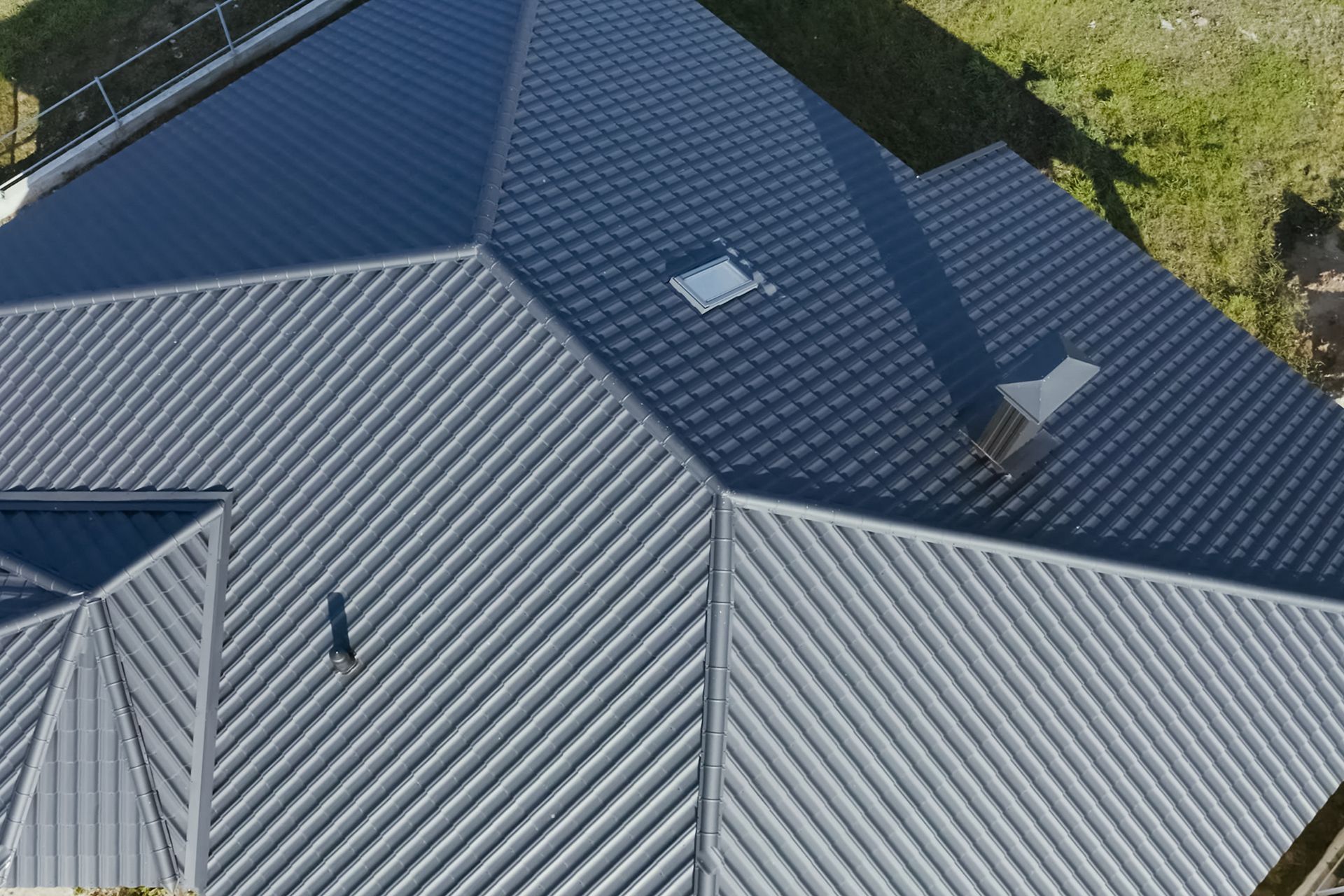An aerial view of a building with a black roof