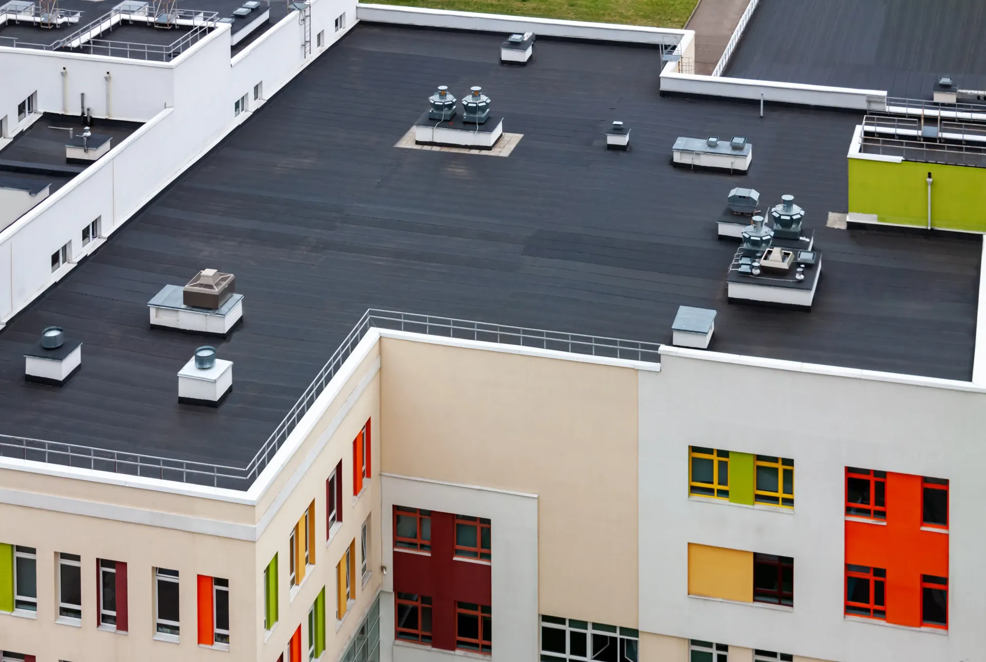 An aerial view of a building with a black roof