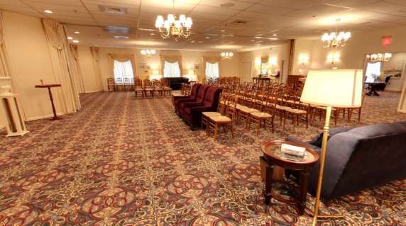 A large room with a lot of furniture and a lamp.