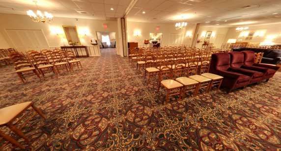 A large room filled with chairs and a couch.