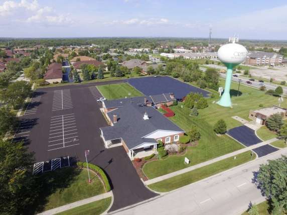An aerial view of a building with a water tower in the background.