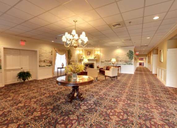 A long hallway with a table and chairs in the middle