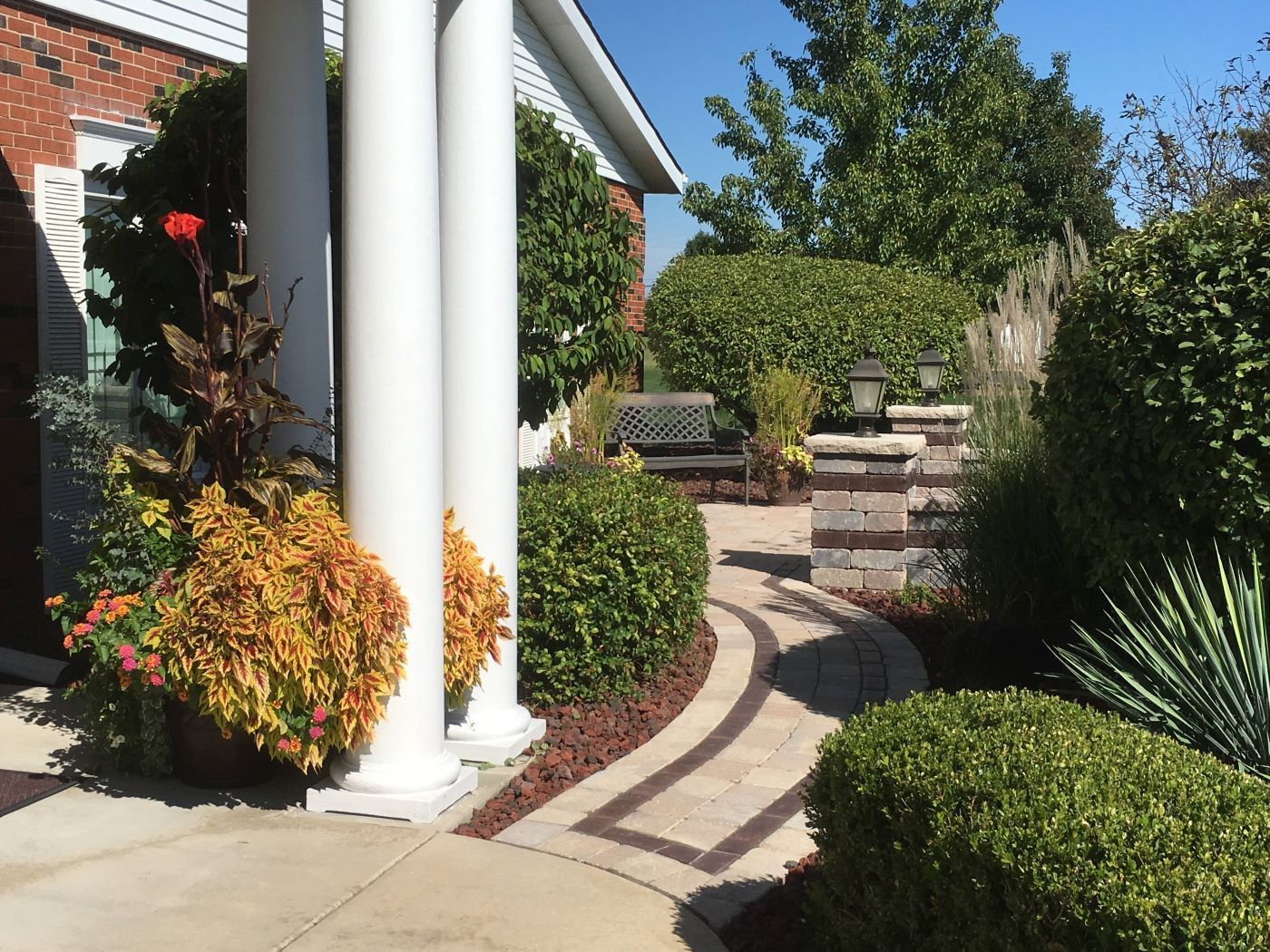 A person is holding a wooden bookmark over an open book.