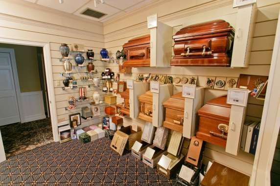 A room filled with lots of coffins and urns.