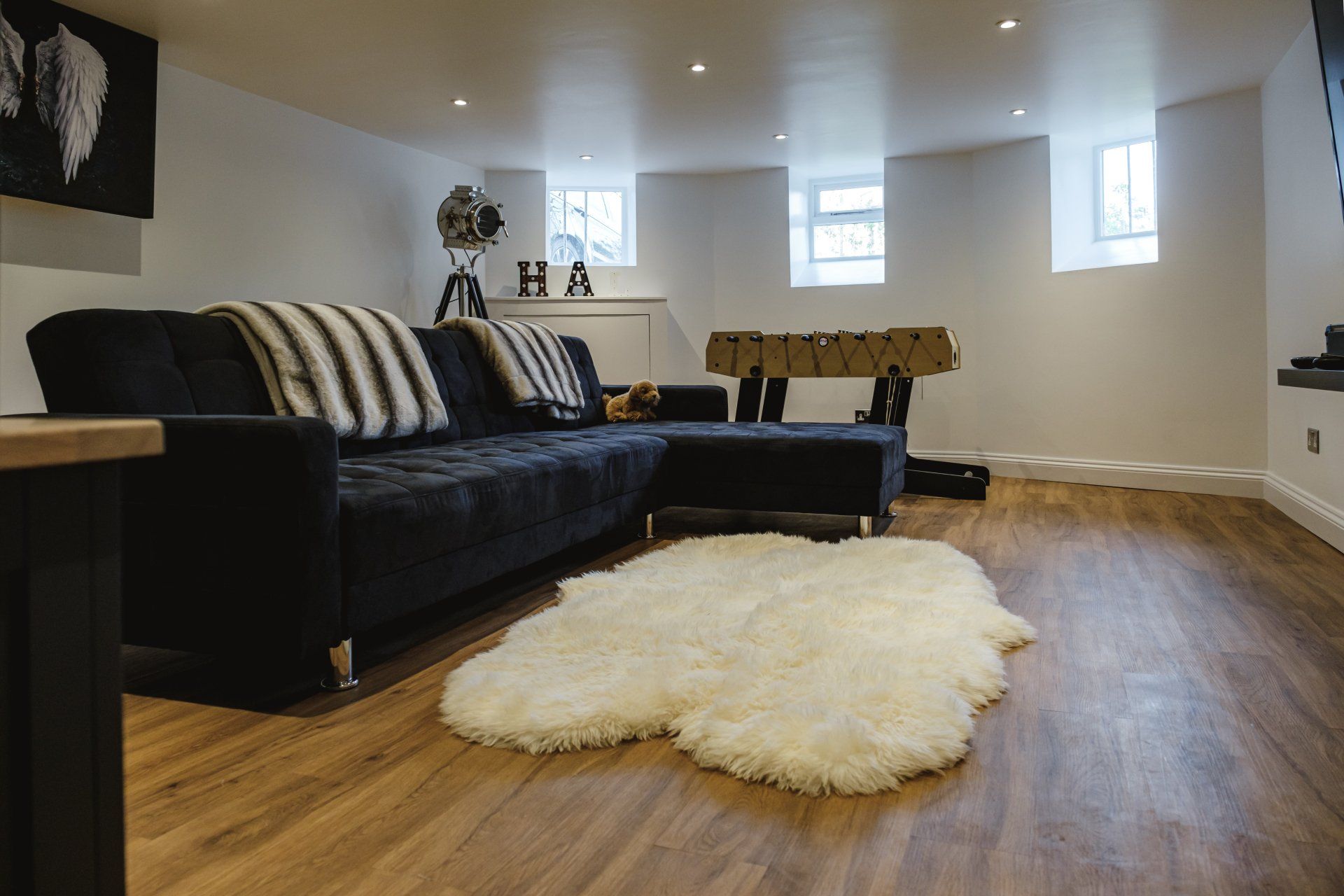 A living room with a couch and a rug on the floor.