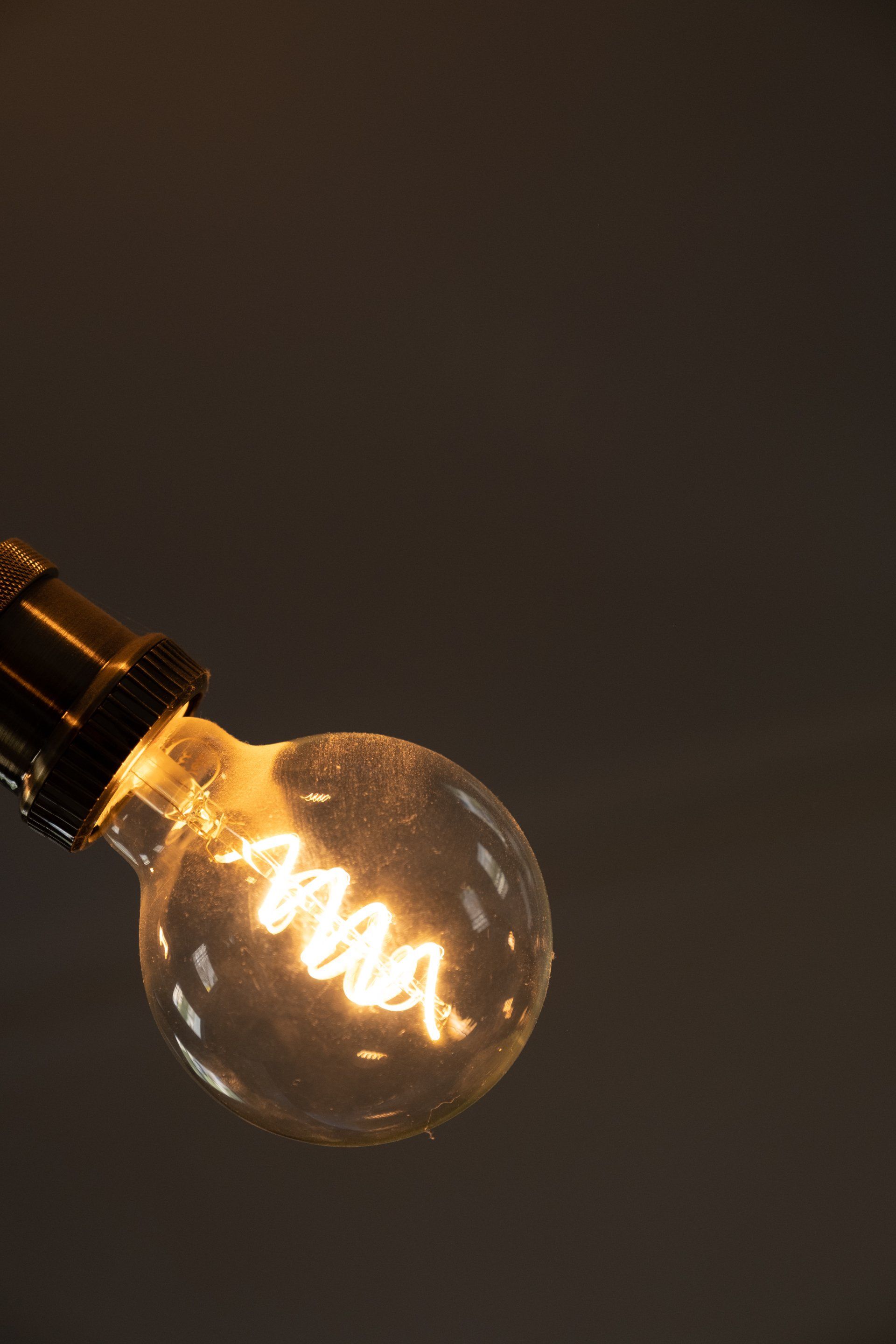 A close up of a light bulb glowing in the dark.