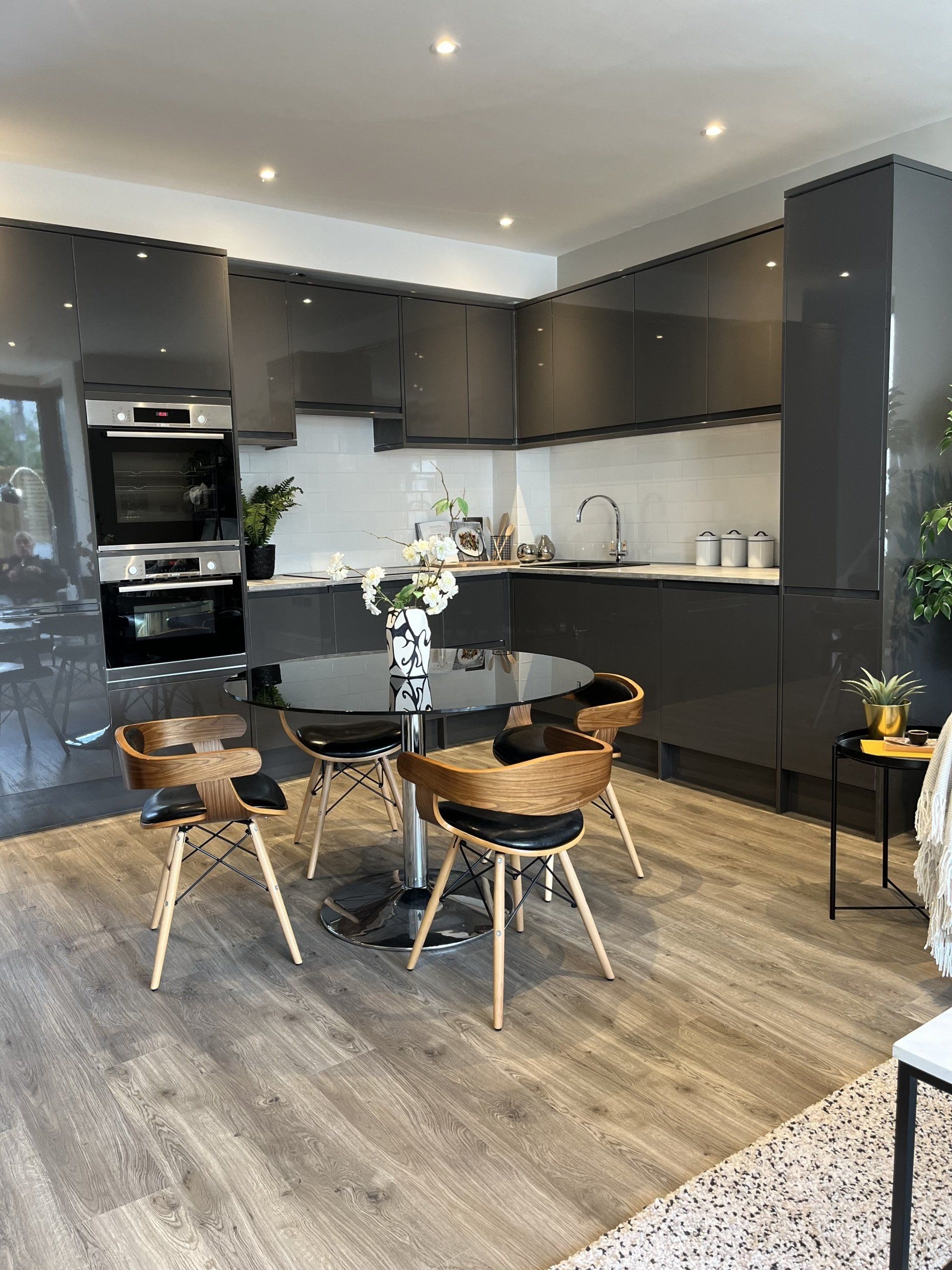 A kitchen with a table and chairs in it
