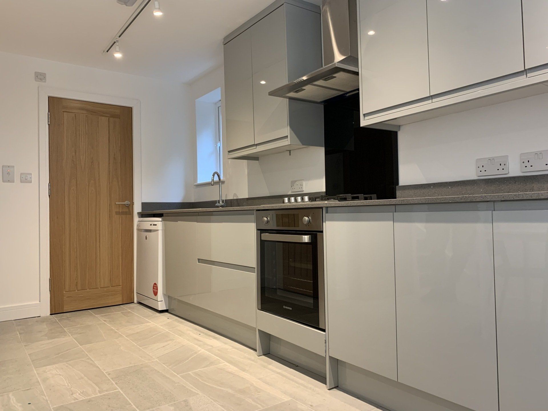 A kitchen with white cabinets and stainless steel appliances.