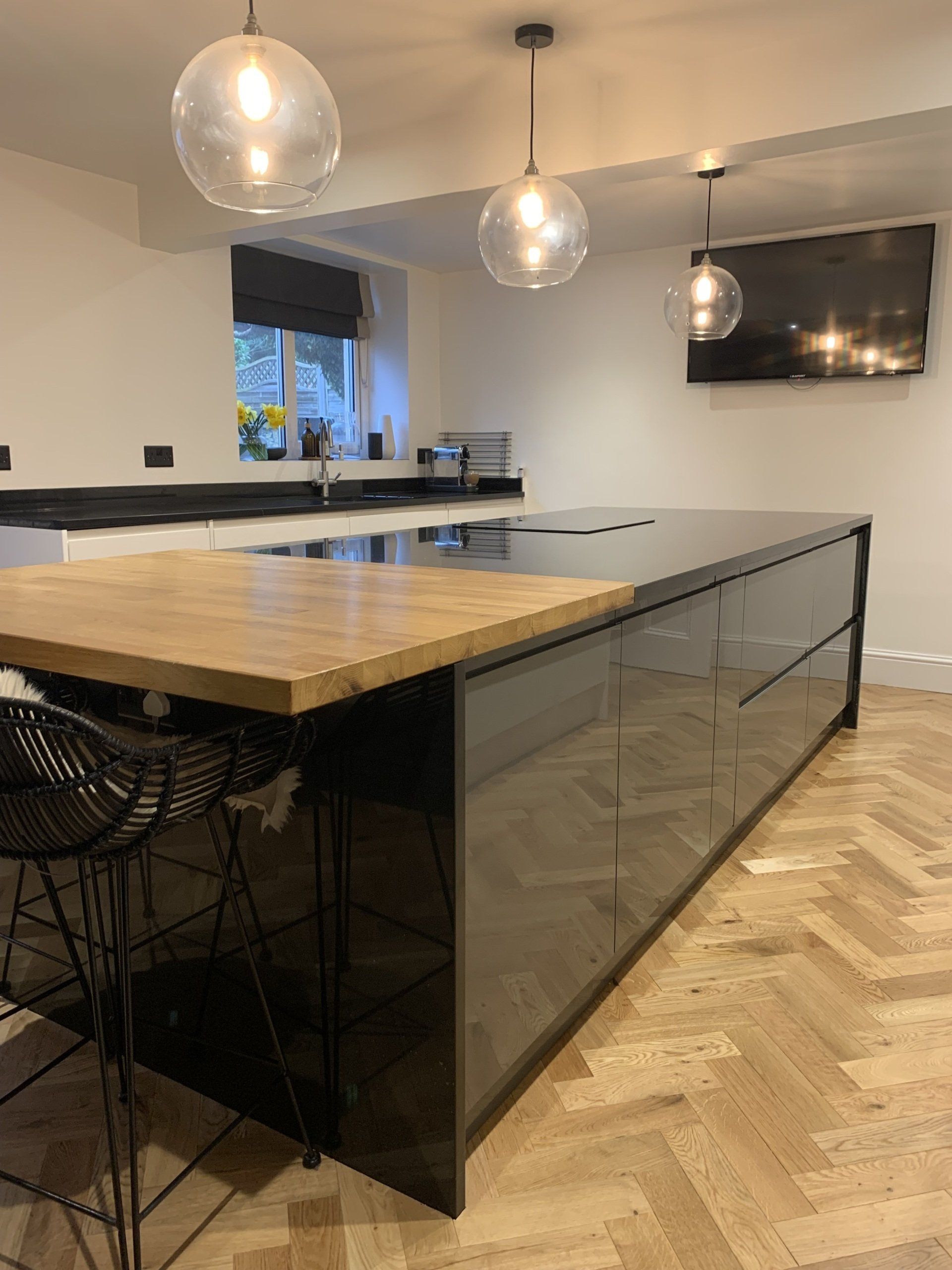 A kitchen with a large island and a wooden table.
