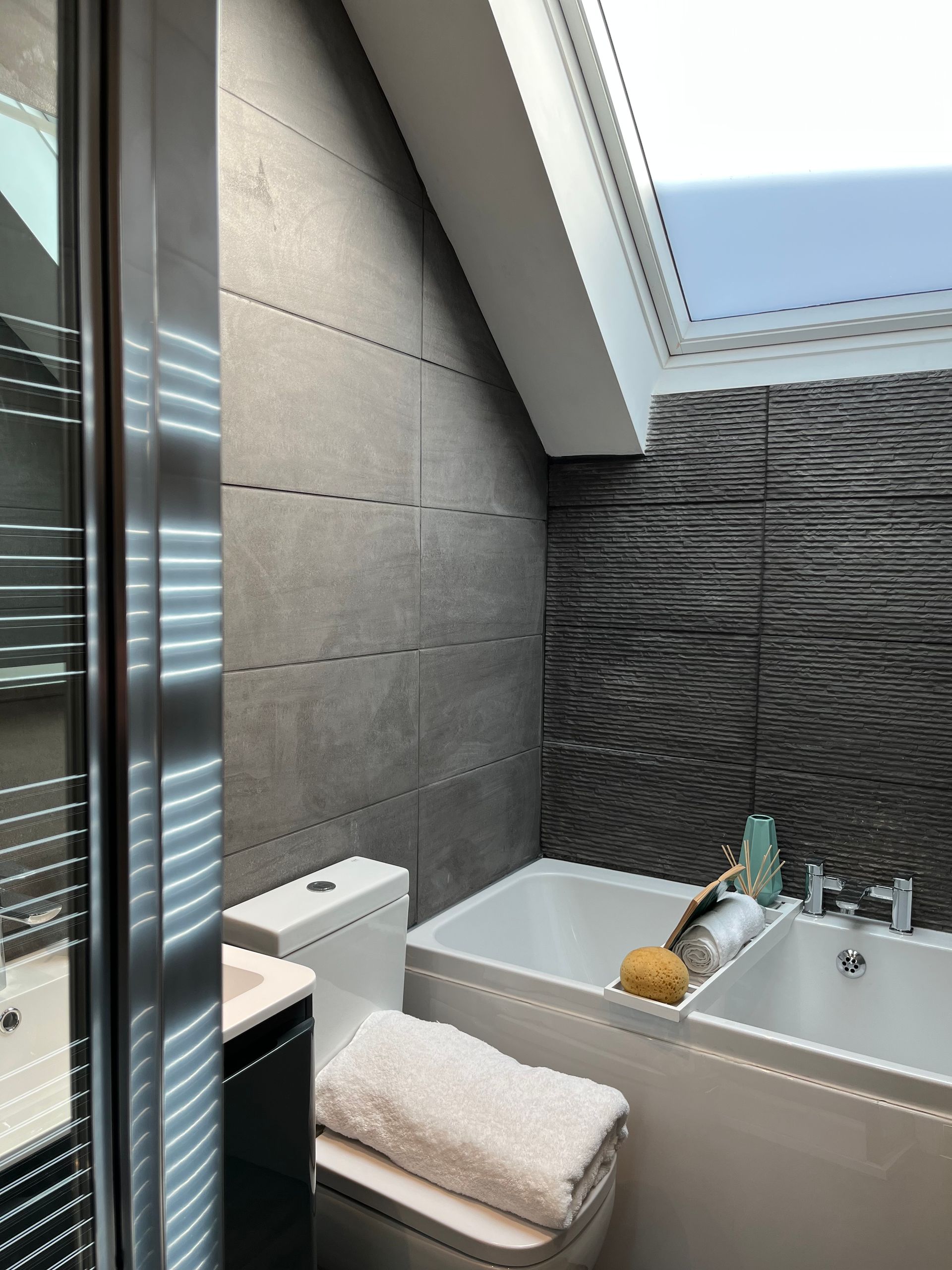 A bathroom with a toilet a sink and a bathtub