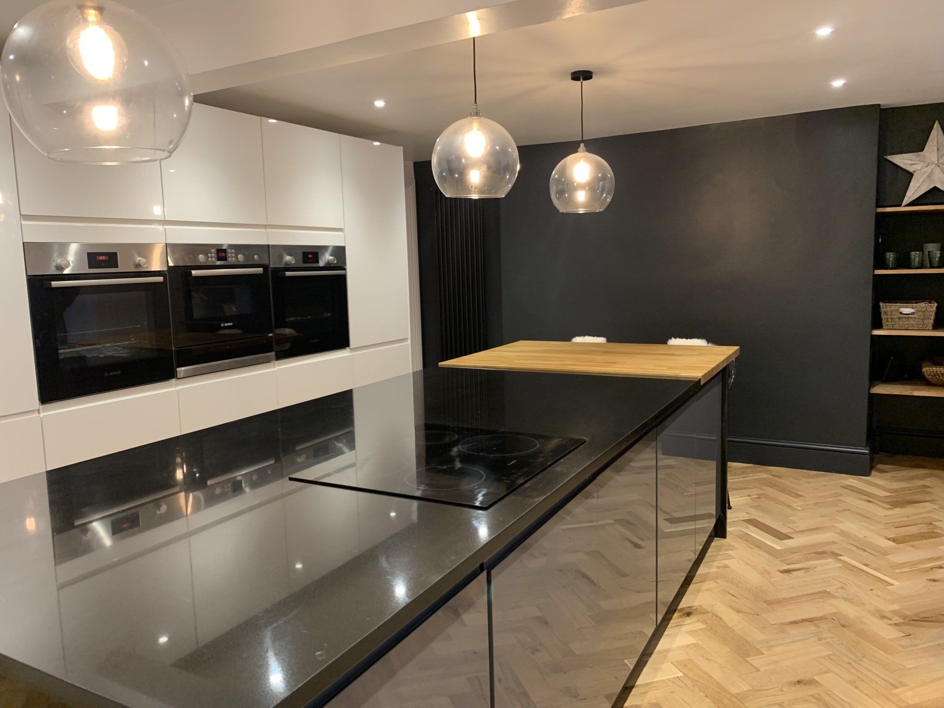 A kitchen with a large island and a stove top oven.