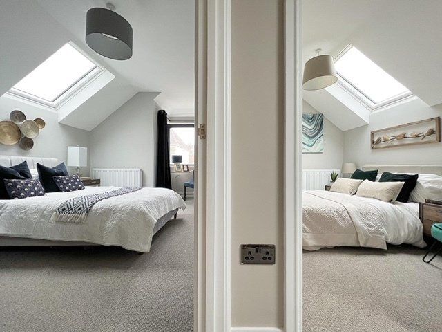 A bedroom with two beds and a skylight on the ceiling