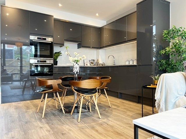 A kitchen with a table and chairs in it