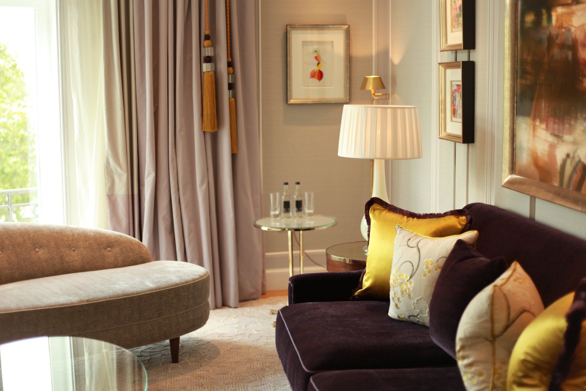 A living room with a purple couch and a gray couch