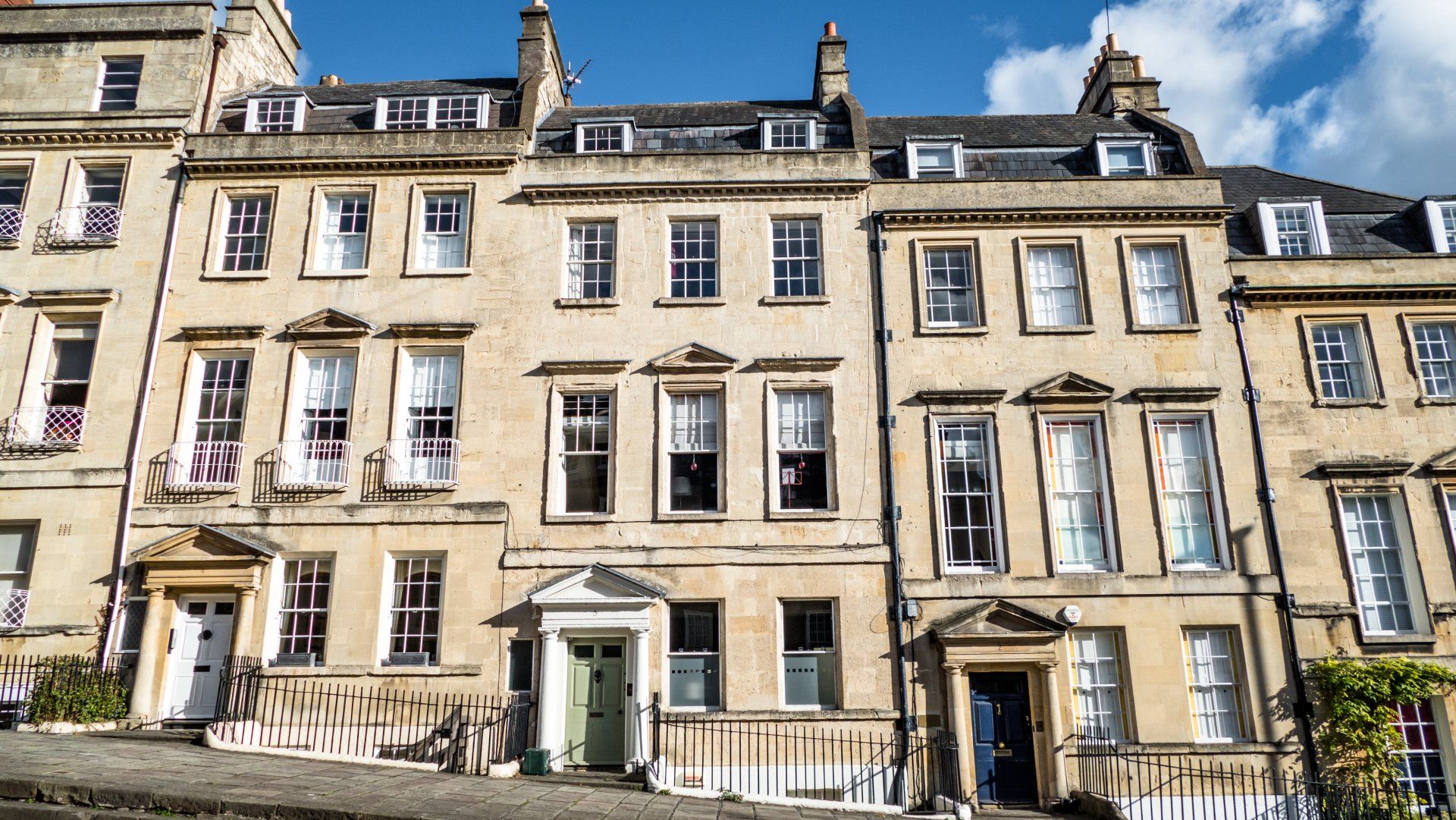 A row of buildings with a blue sky in the background