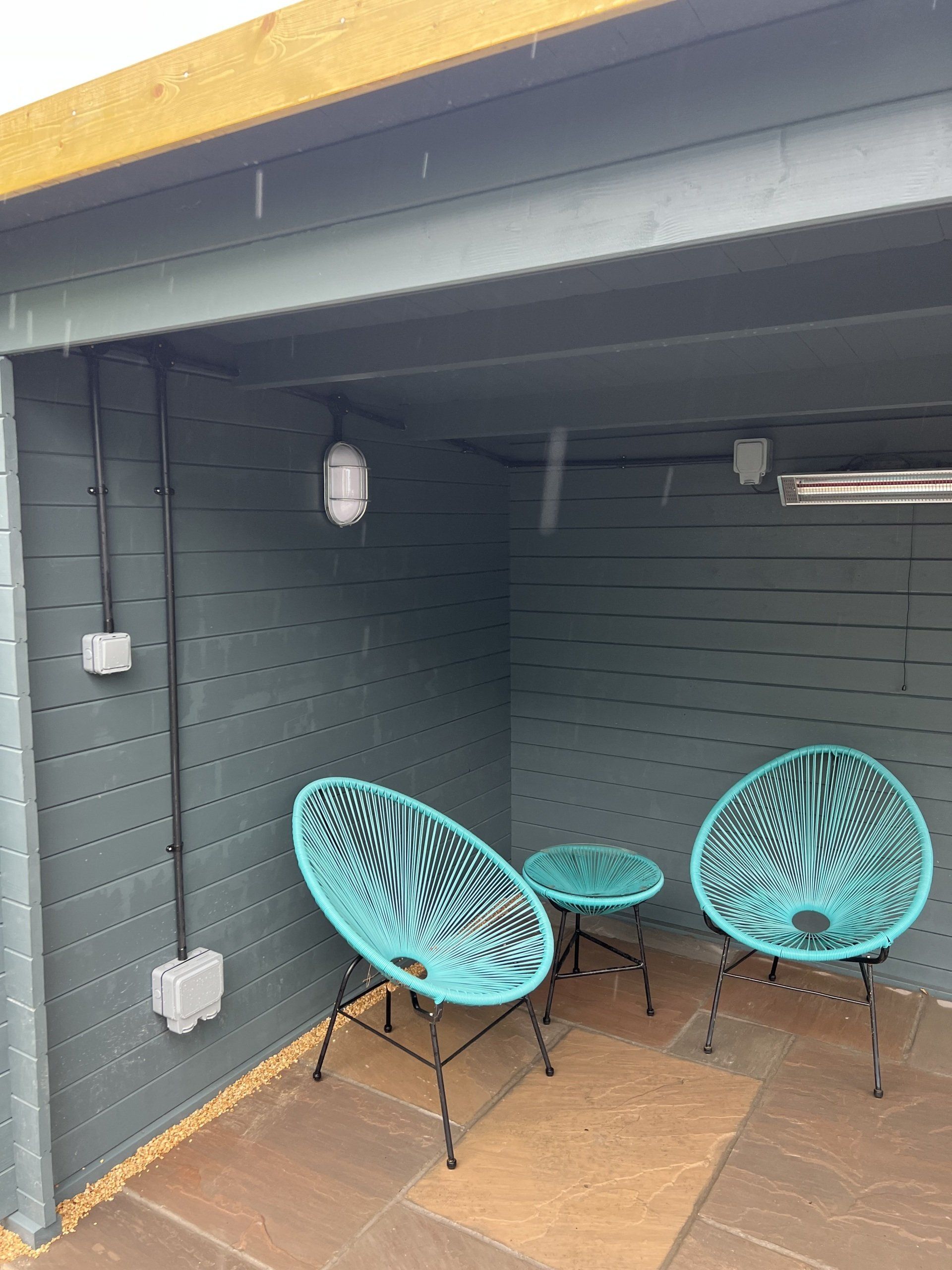 There are two chairs and a table in the room.