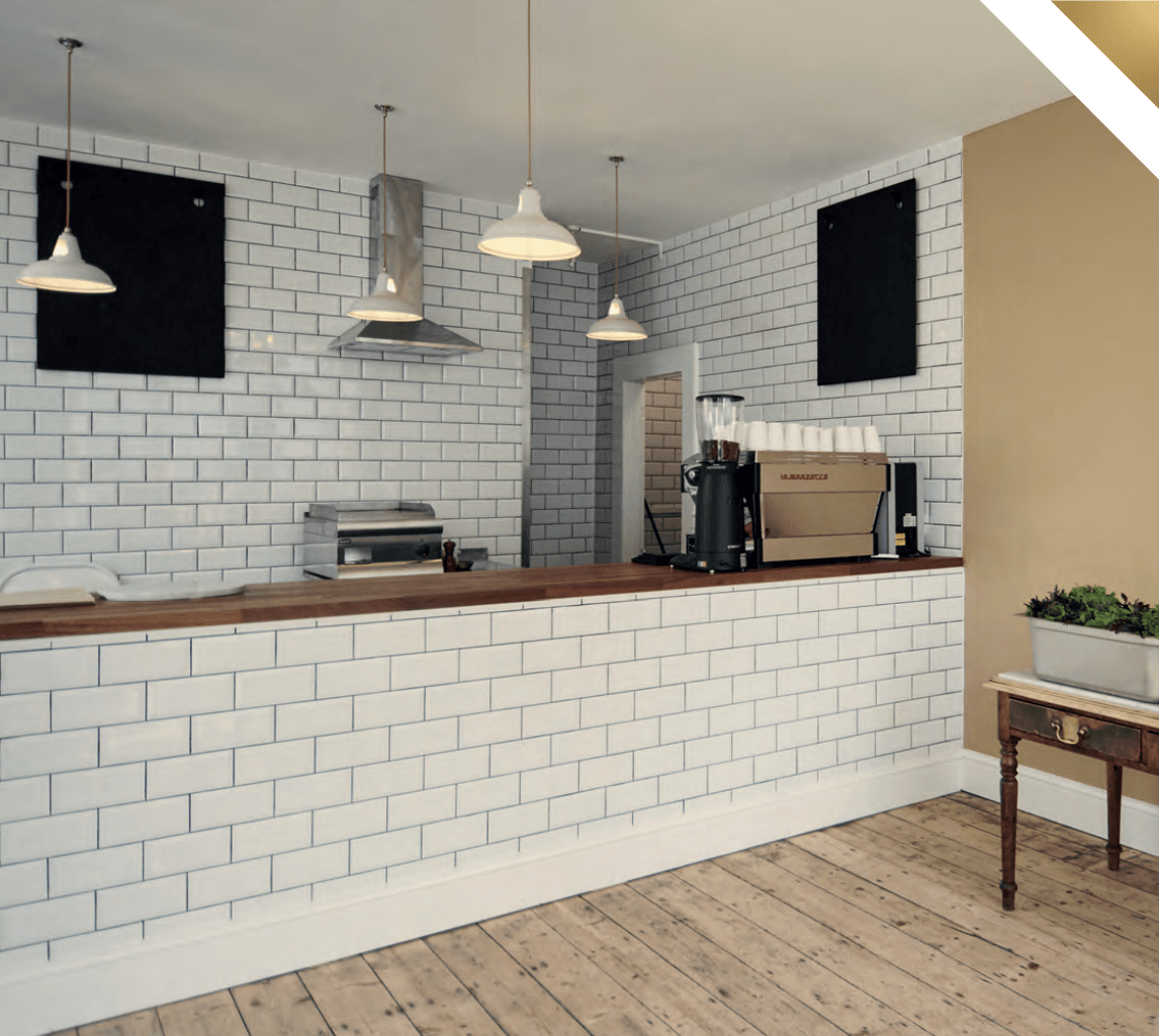A counter in a restaurant with white brick walls