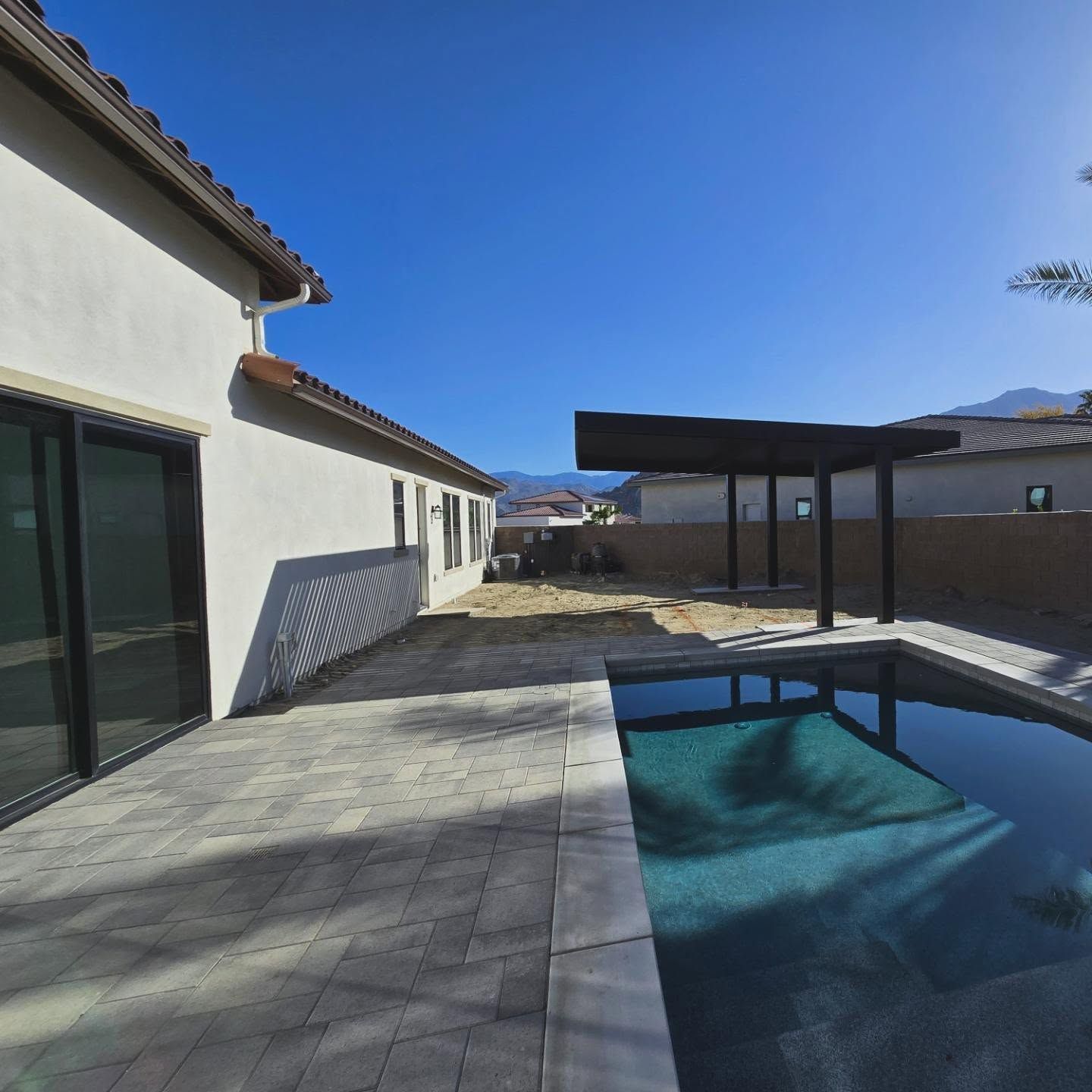 A house with a swimming pool in front of it