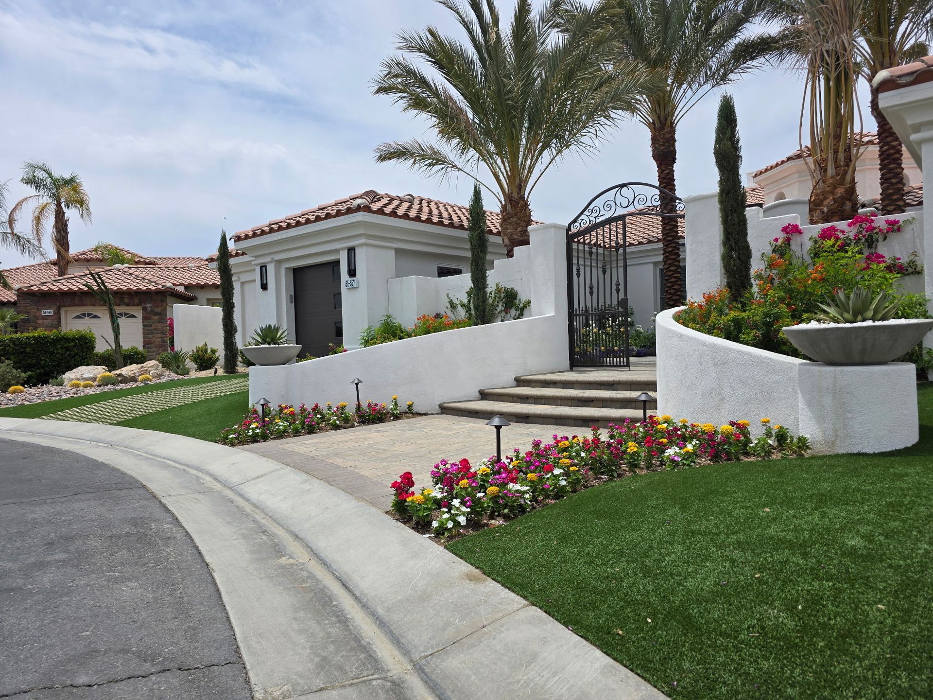 A path with circles in the grass leading to a house