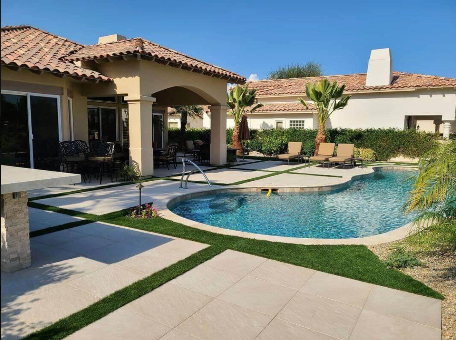 A house with a large swimming pool in front of it