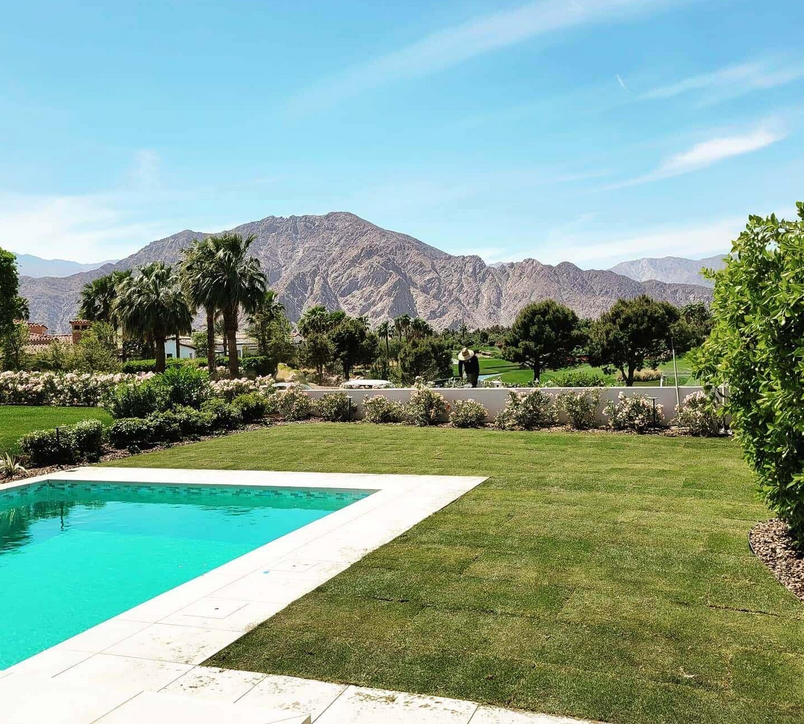 A large swimming pool with mountains in the background