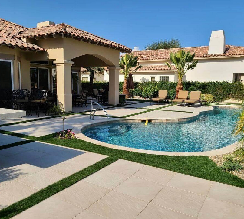 A house with a large swimming pool in front of it