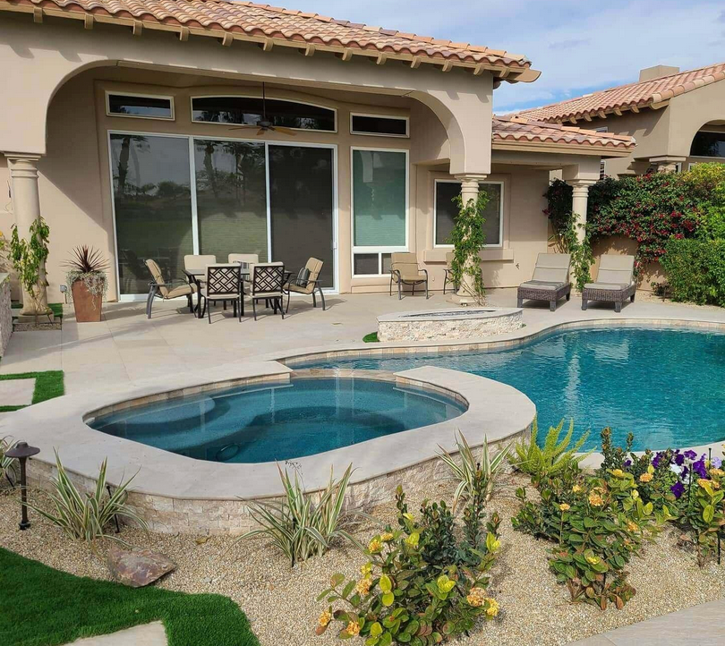 A house with a large swimming pool and a hot tub