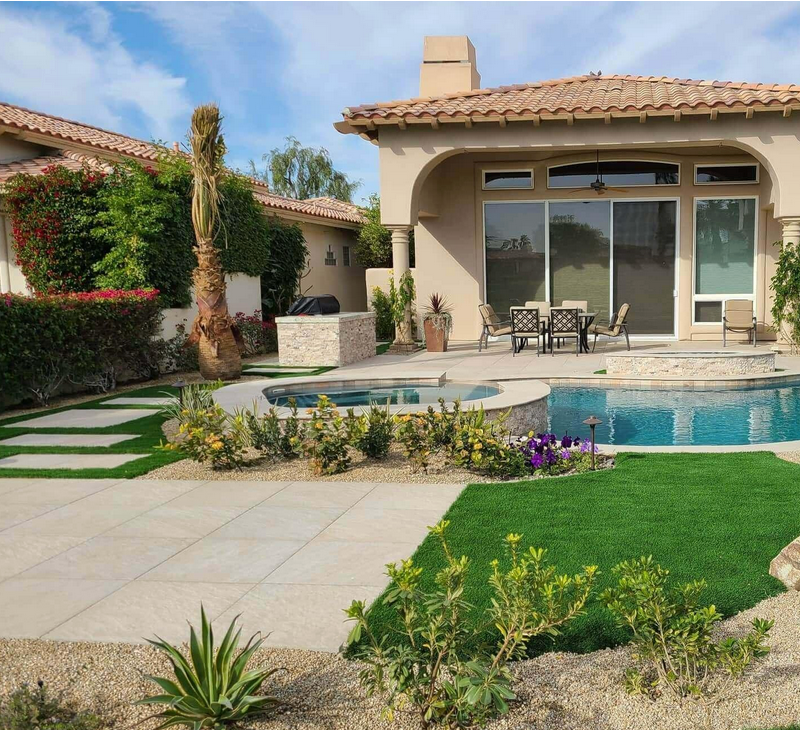 A house with a swimming pool in front of it