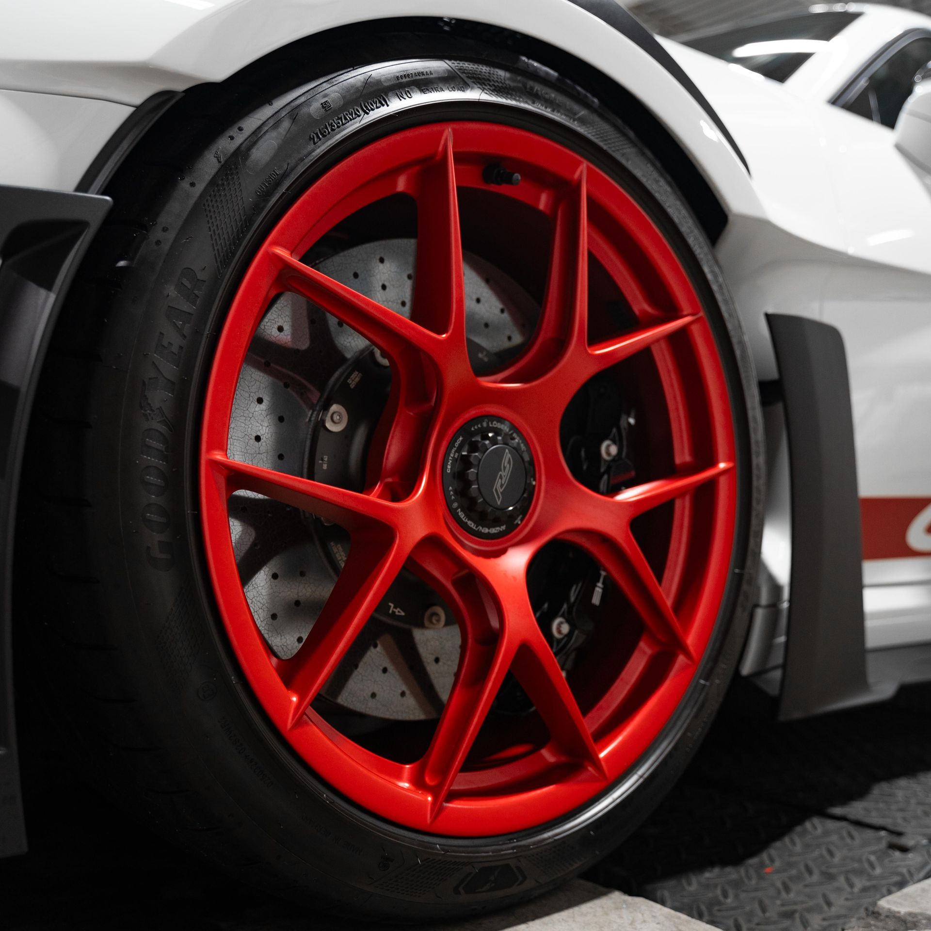a close up of a car wheel with the word porsche on it