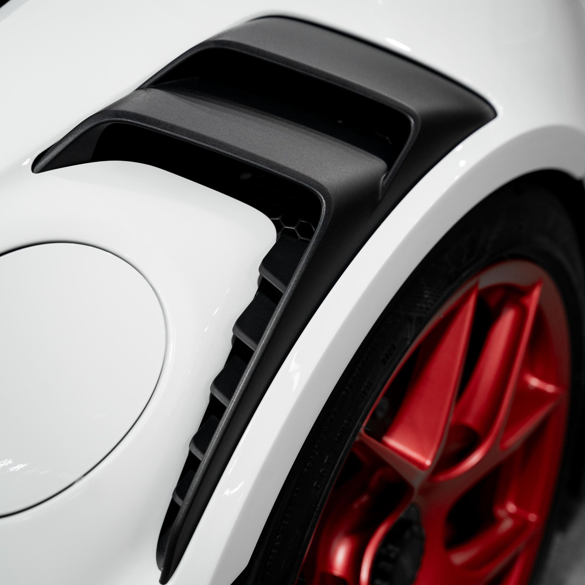 a close up of a car fender with water drops on it