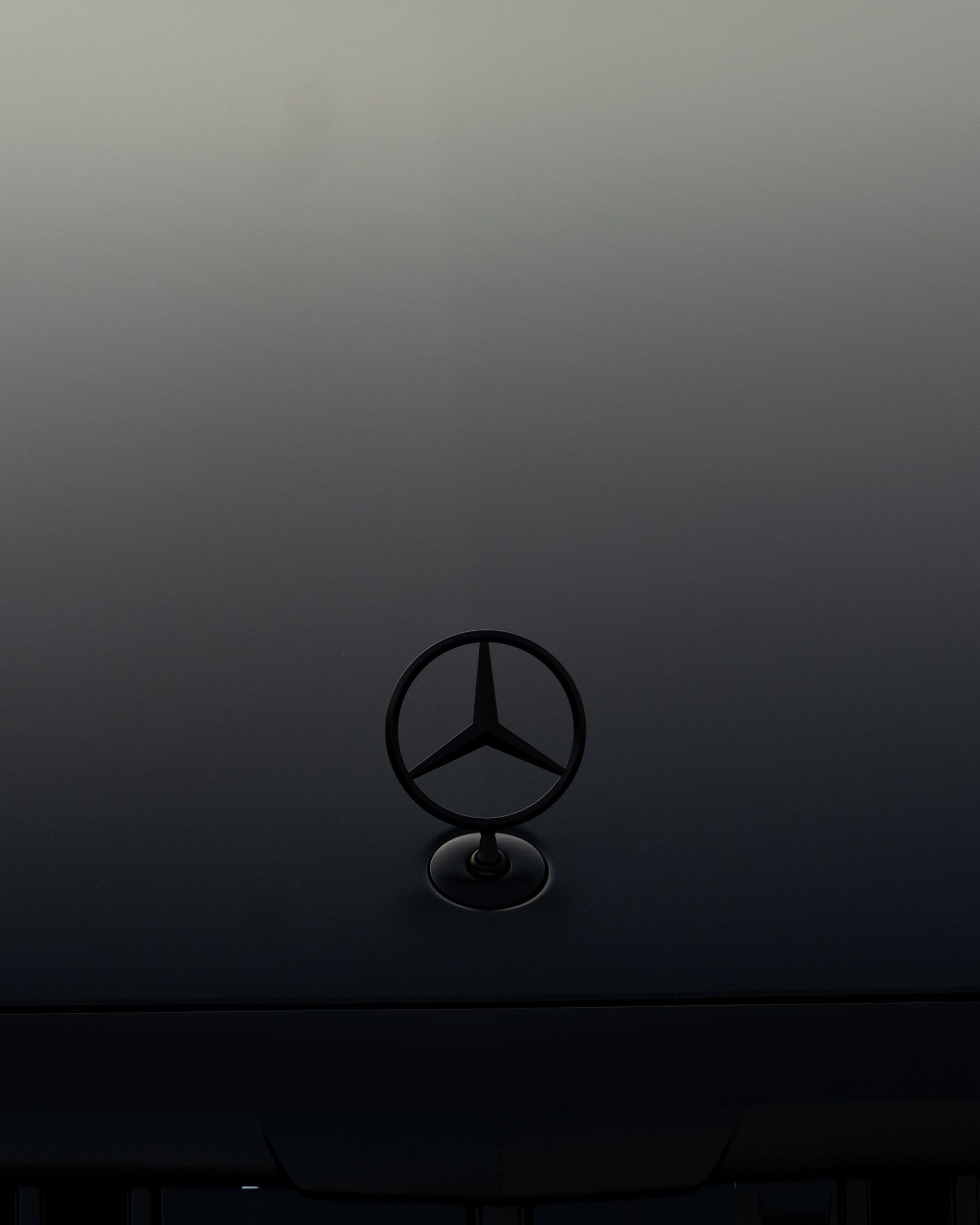 a black mercedes logo is on the hood of a car .