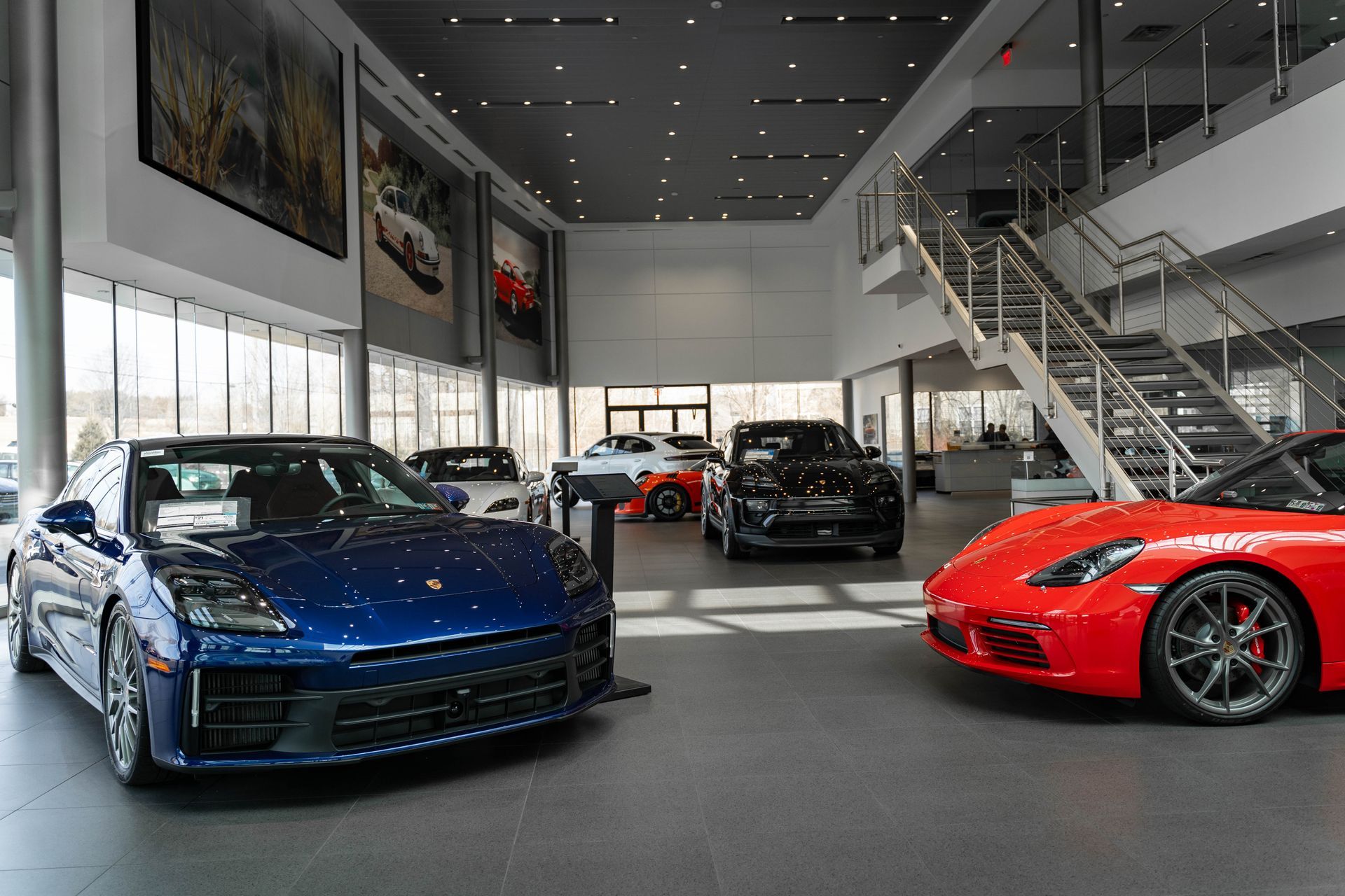 a blue porsche taycan is parked in a garage .
