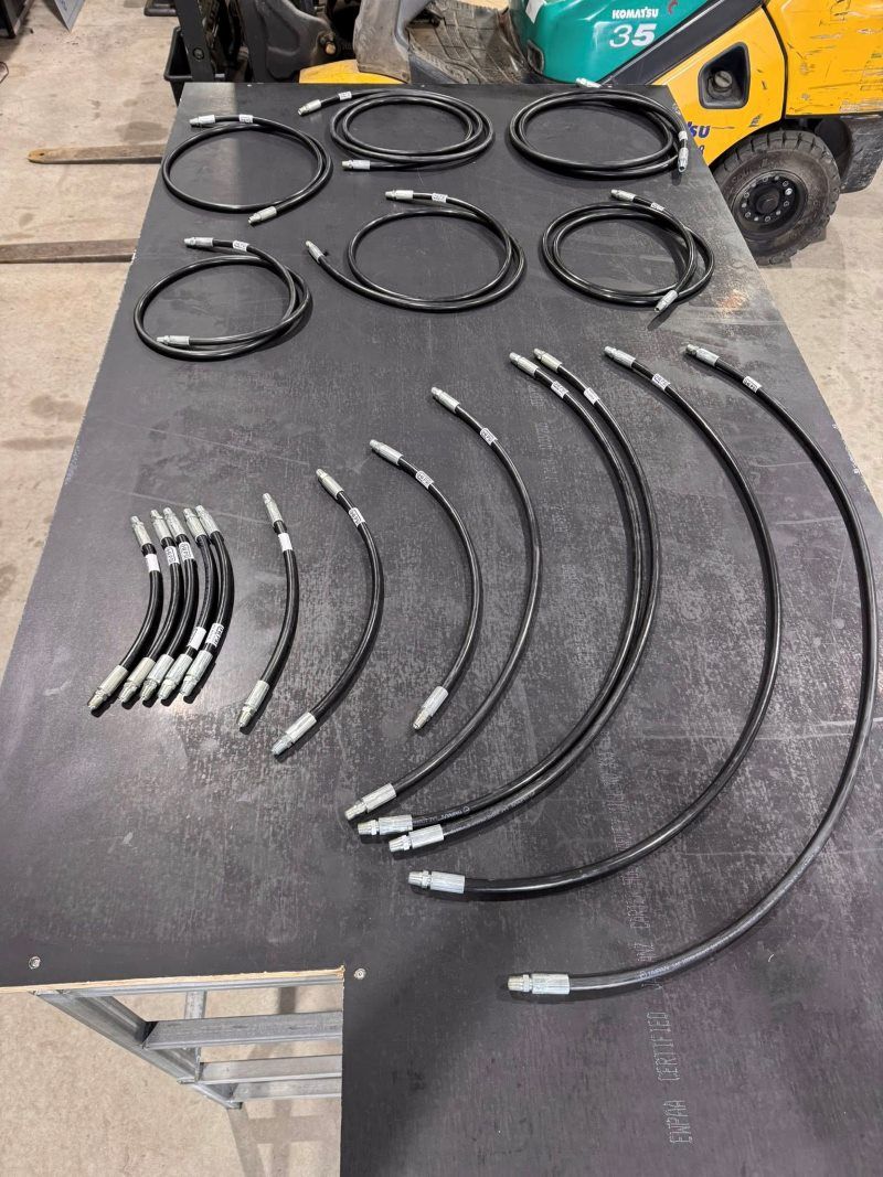 A Bunch Of Hydraulic Hoses Are Sitting On A Table — HI PSI Hydraulics in Wauchope, NSW