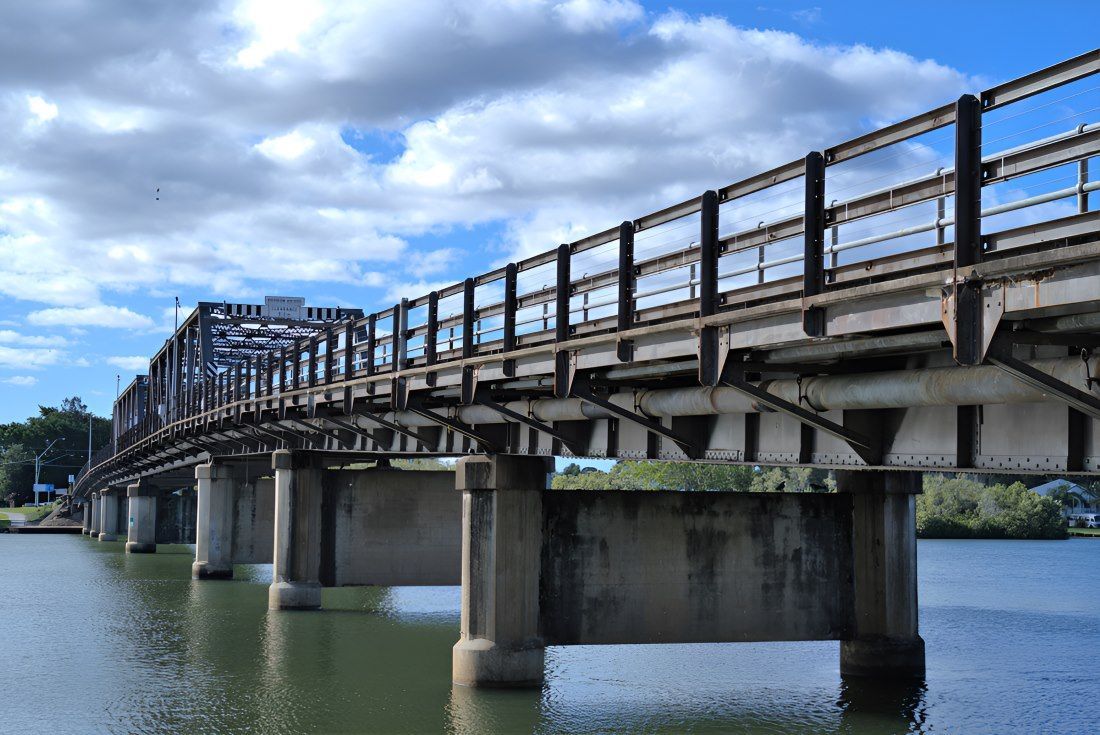 A Bridge Over A Body Of Water With A Blue Sky In The Background — HI PSI Hydraulics in Macksville, NSW