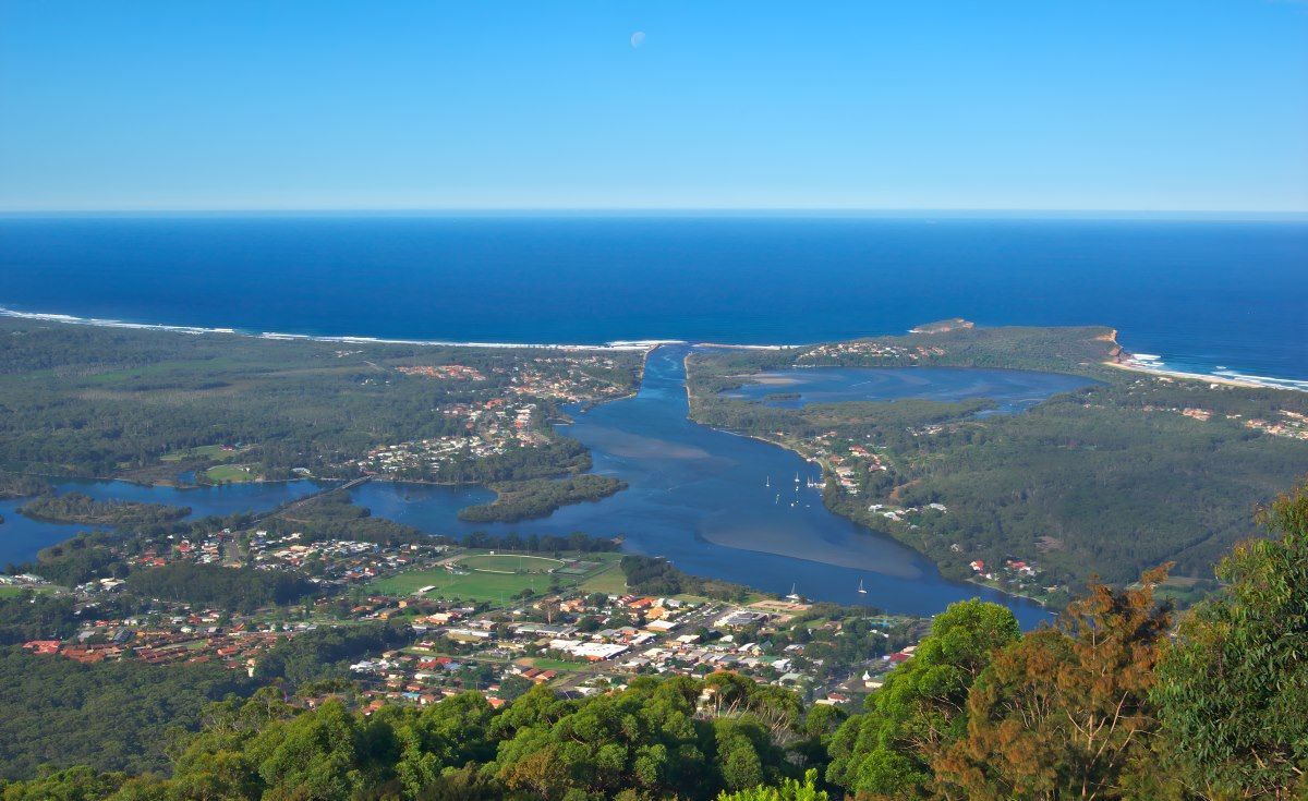 An Aerial View Of A River Surrounded By Trees And A Body Of Water  — HI PSI Hydraulics in Laurieton, NSW
