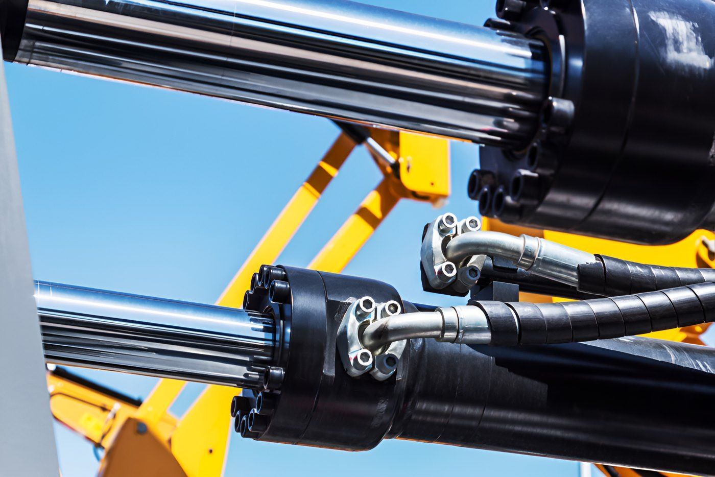 A close up of hydraulic cylinders and hoses on a machine — HI PSI Hydraulics in Kempsey, NSW