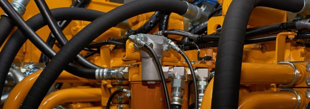A Close Up Of A Yellow Engine With A Bunch Of Hoses Attached To It — HI PSI Hydraulics in South West Rocks, NSW