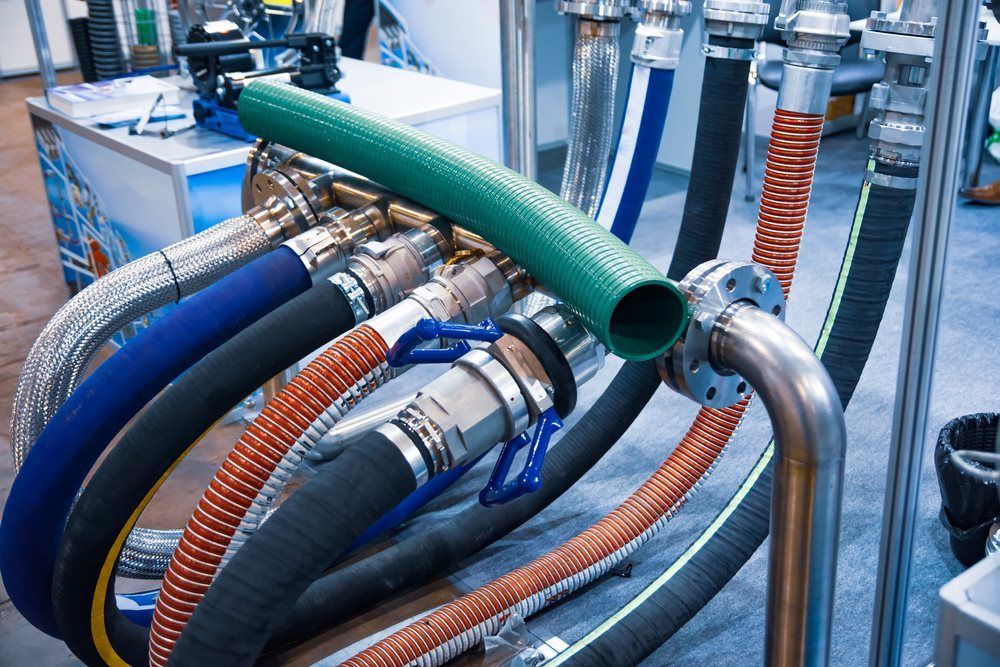 A Bunch Of Different Colored Hoses Are Sitting On A Table — HI PSI Hydraulics in Harrington, NSW