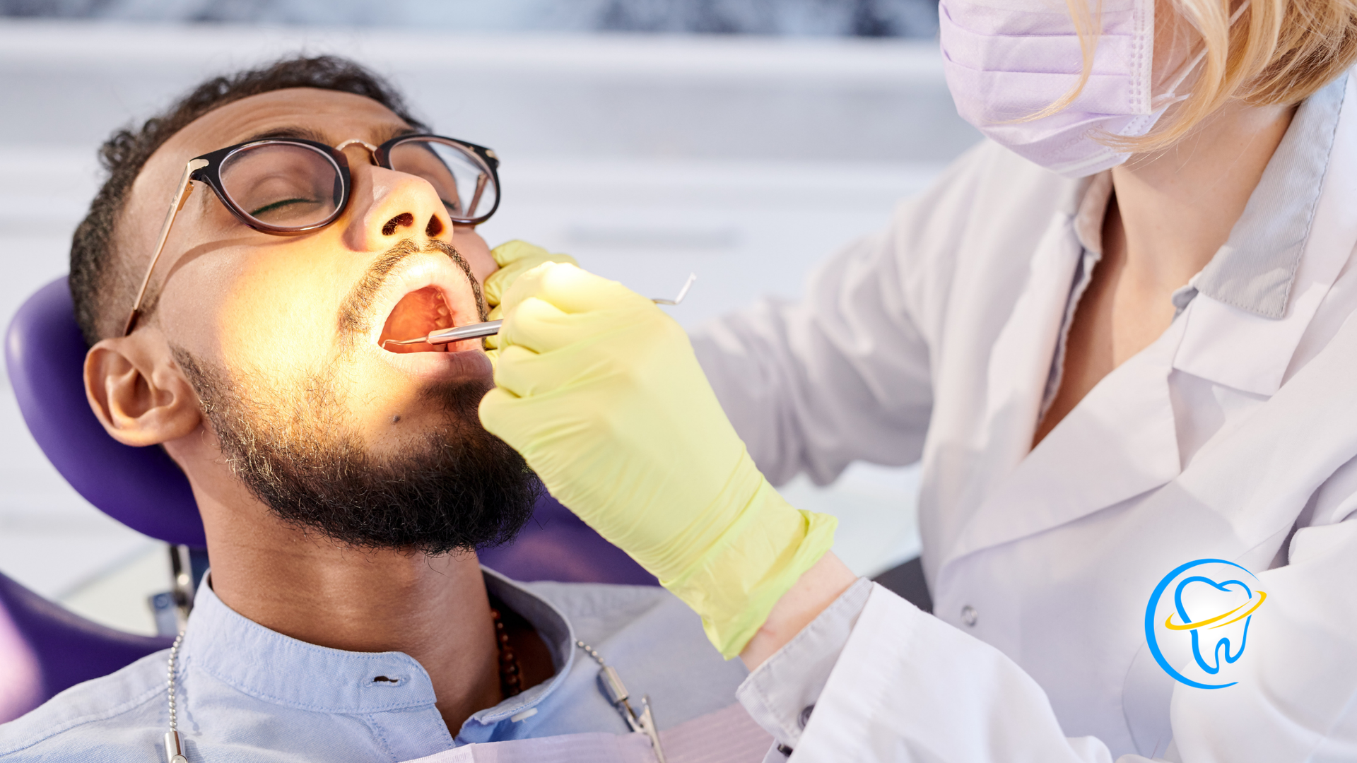 A man is getting his teeth examined by a dentist.