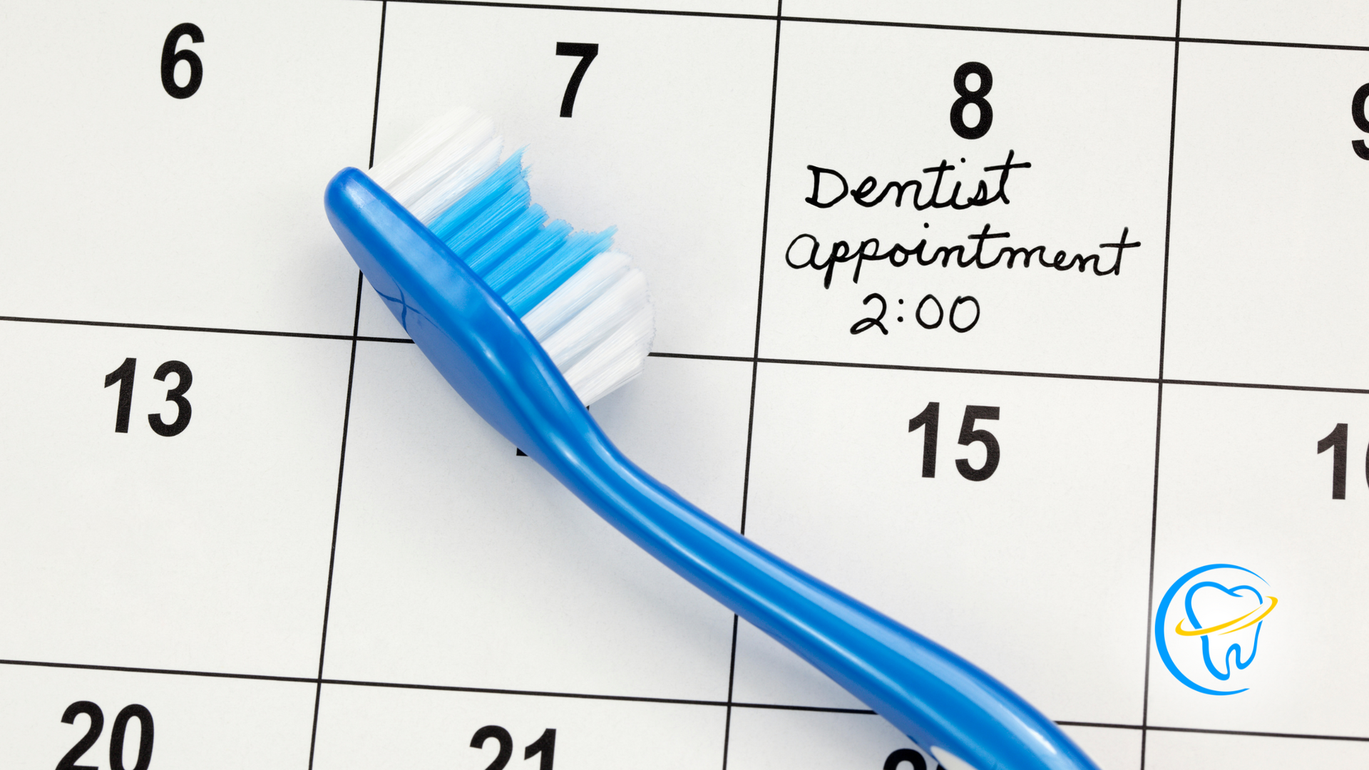 A blue toothbrush sitting on top of a calendar that says dentist appointment 2:00