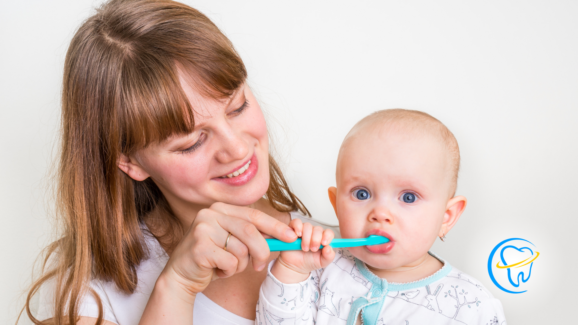 A woman is brushing a baby 's teeth with a toothbrush.
