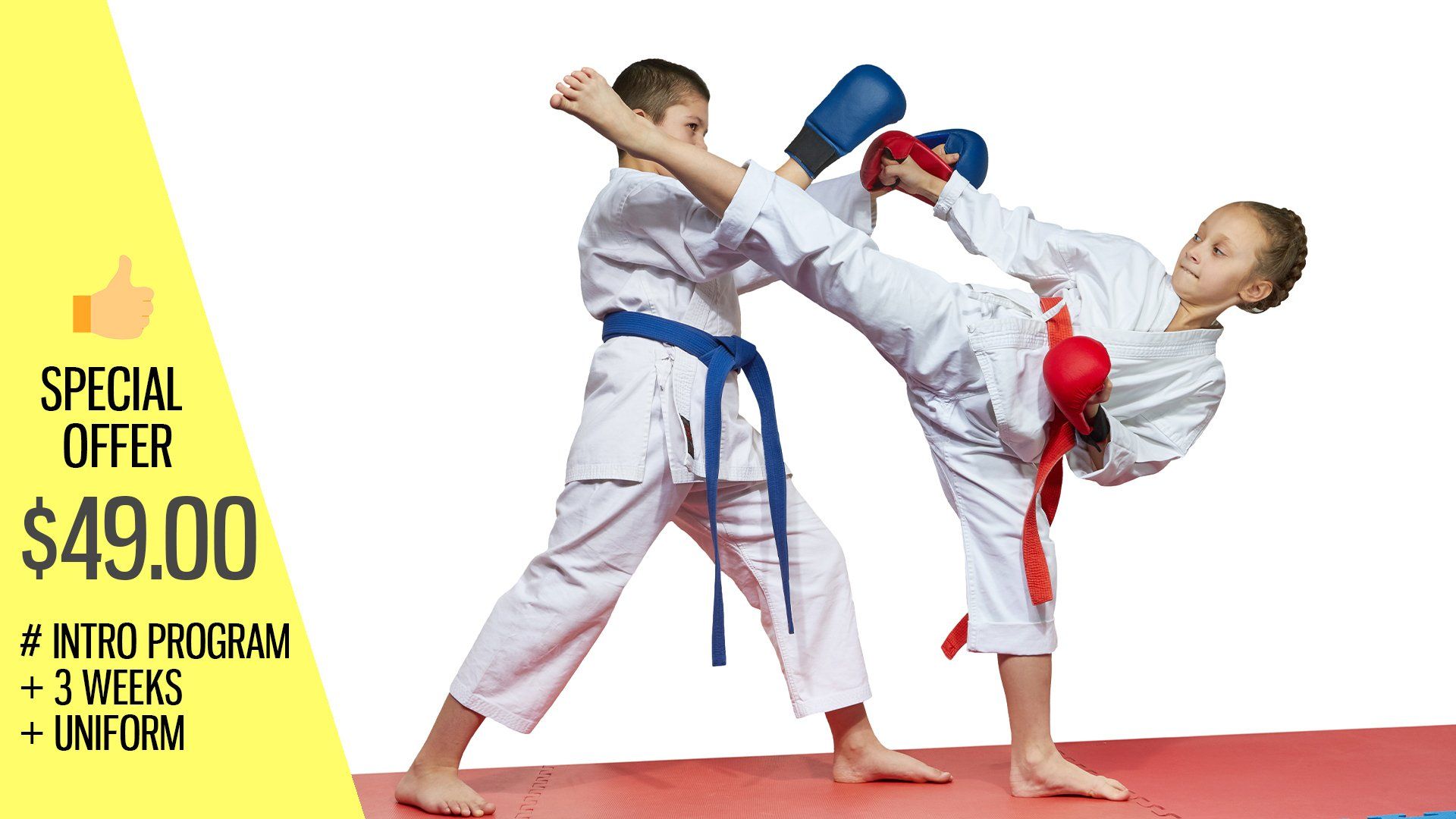 A boy and a girl are practicing karate on a mat.