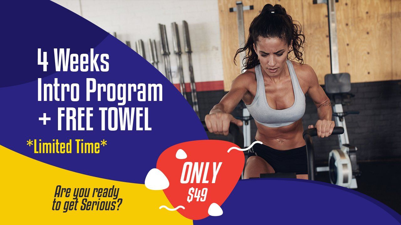 A woman is doing exercises in a gym with a sign that says 4 weeks intro program + free towel