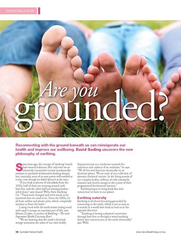 A woman in a blue sports bra and silver shorts is standing next to a pink ball.