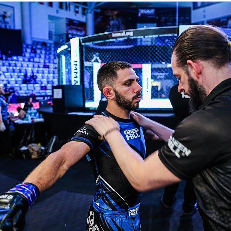 A man in a blue shirt that says good hill on it