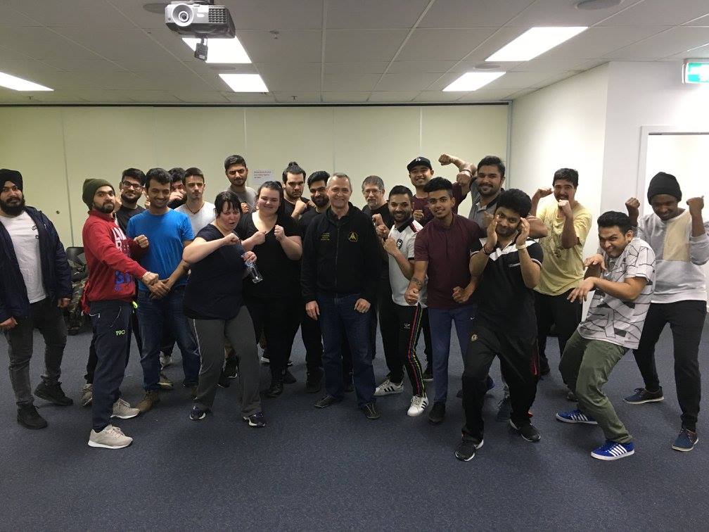 A group of people are posing for a picture in a room.