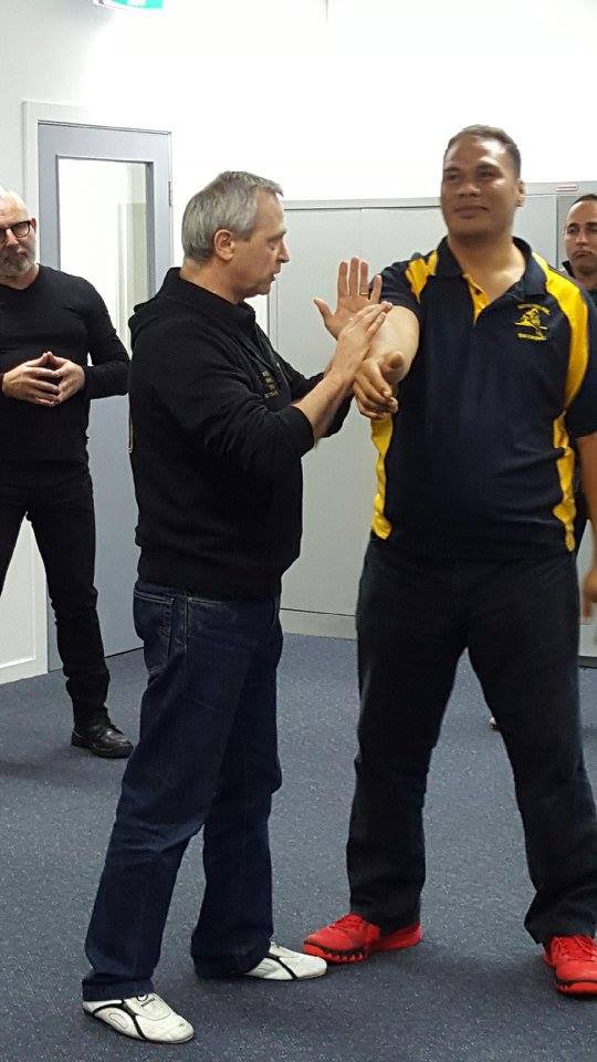 A group of men are standing next to each other in a room.